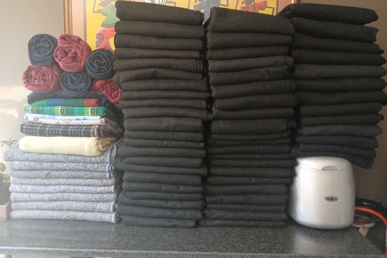 Seventy-seven folded blankets stacked and counted before delivery