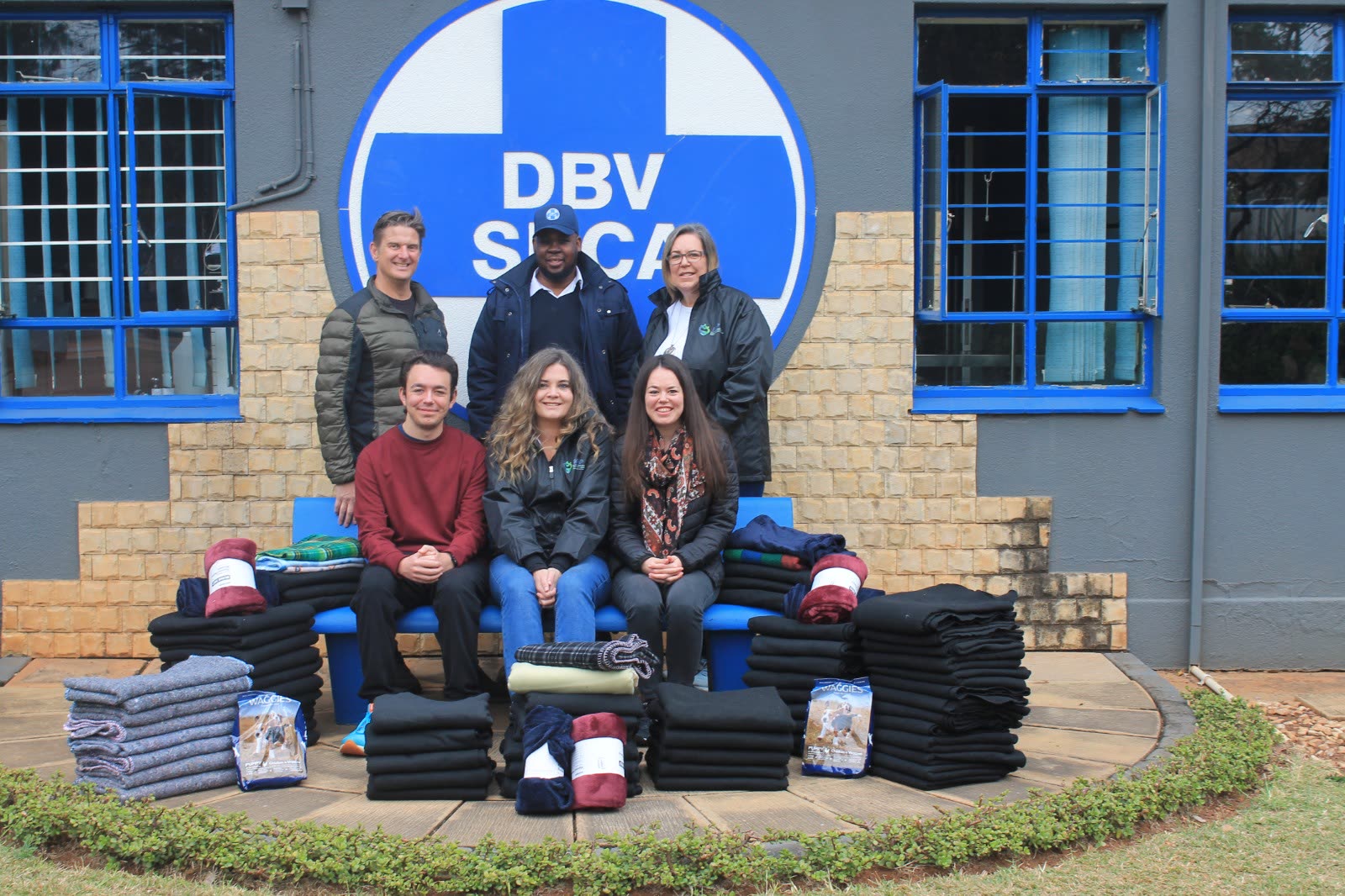 MAP volunteers with SPCA staff and stacks of donated blankets at the Tshwane SPCA
